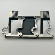 2 Brushed steel watch stands connected on either side of a vanity tray with leather inlay