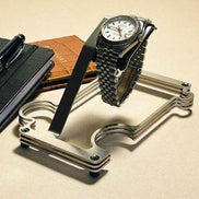 Puzzle Stand wit a rolex . there is a passport and notepad in the background