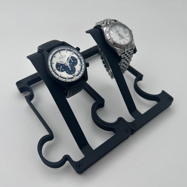 2 Puzzle watch stands in Black powder coated finish and a zenith and rolex watch sitting on them