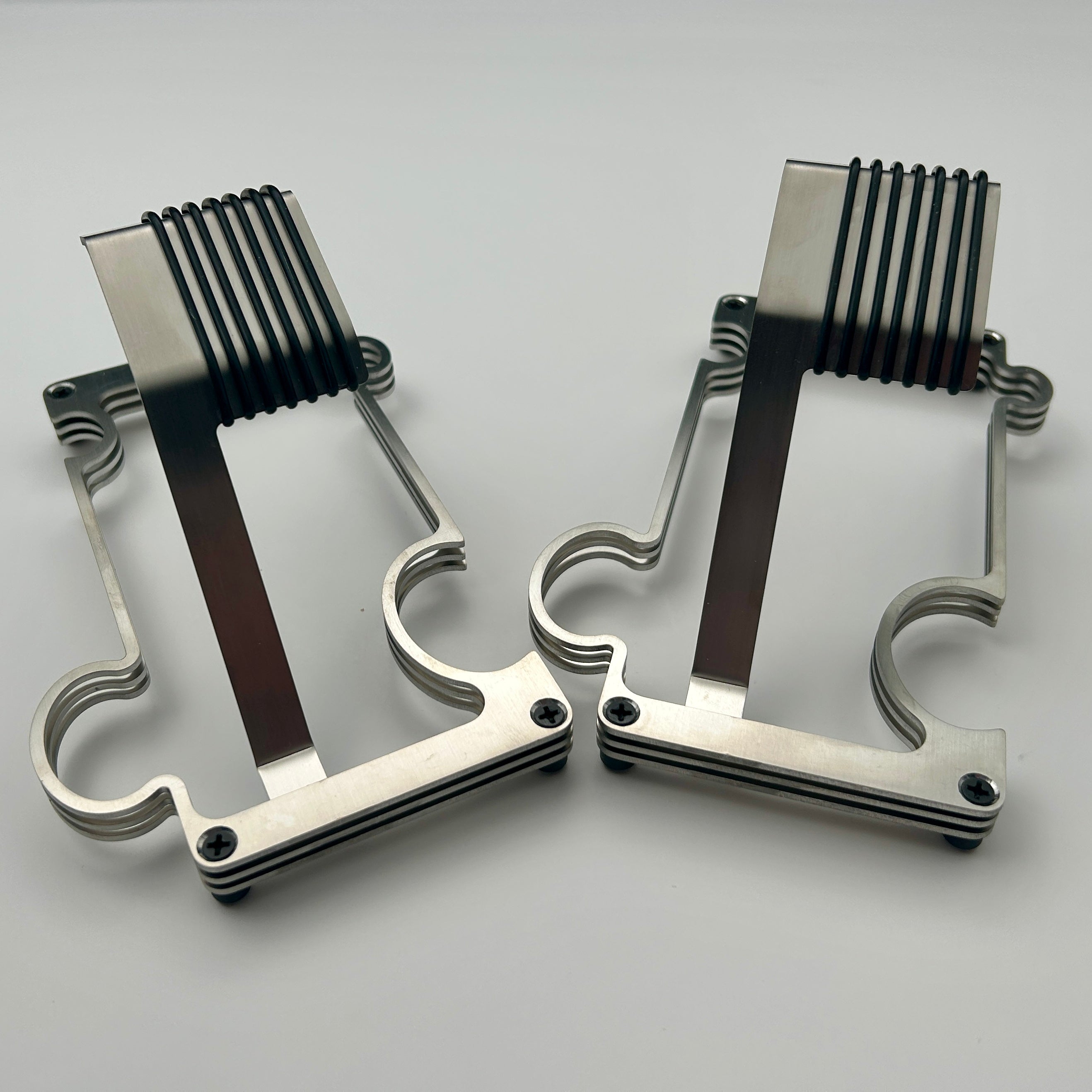 2 Puzzle watch stands side by side in brushed steel