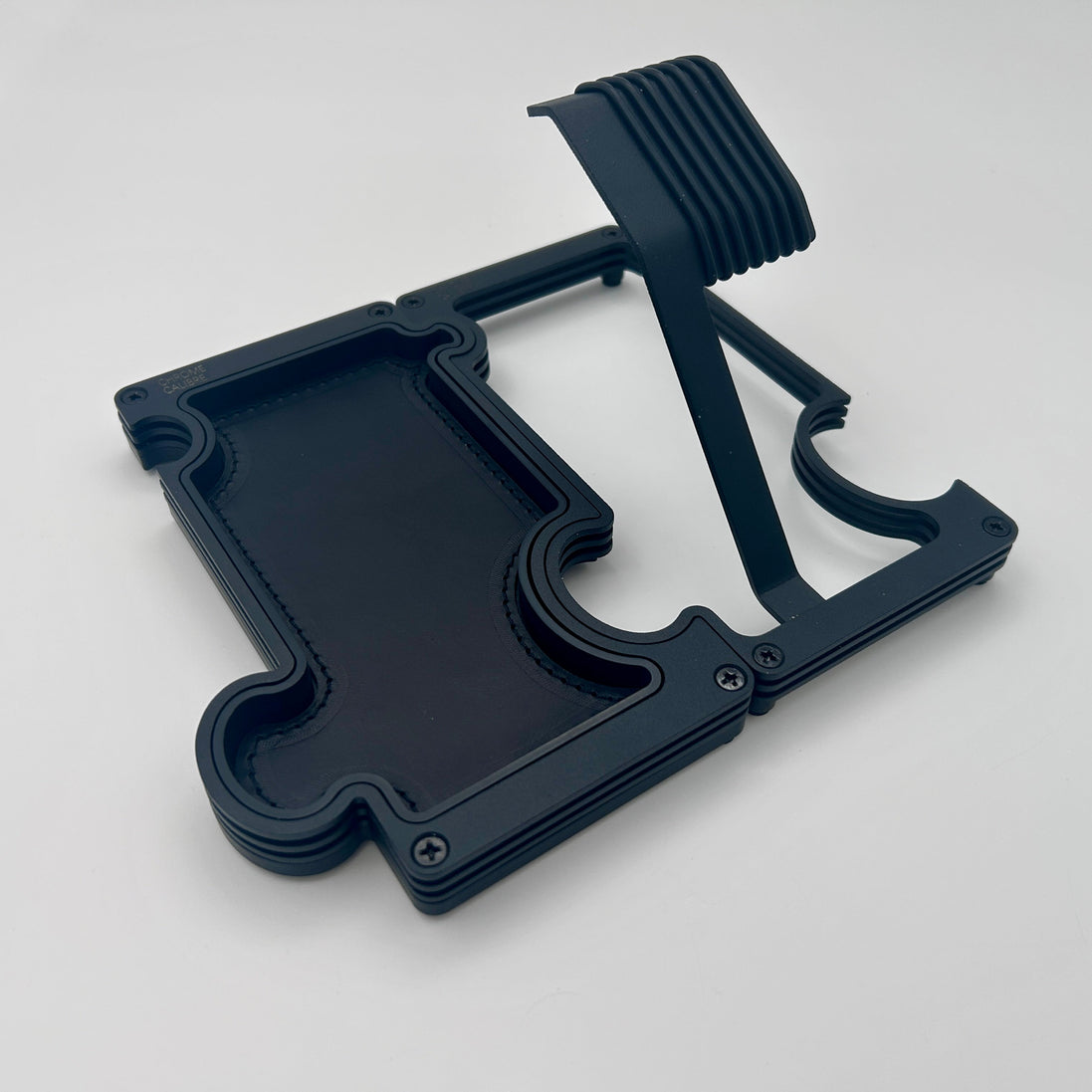 A black watch stand and vanity tray set on a white background