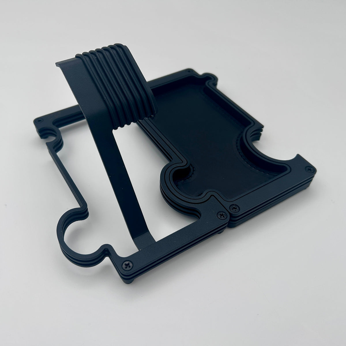 A black watch stand and vanity tray set on white background