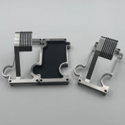 Two metallic objects on a light gray surface