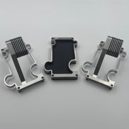 2 puzzle watch stands and 1 vanity tray in brushed steel on white background