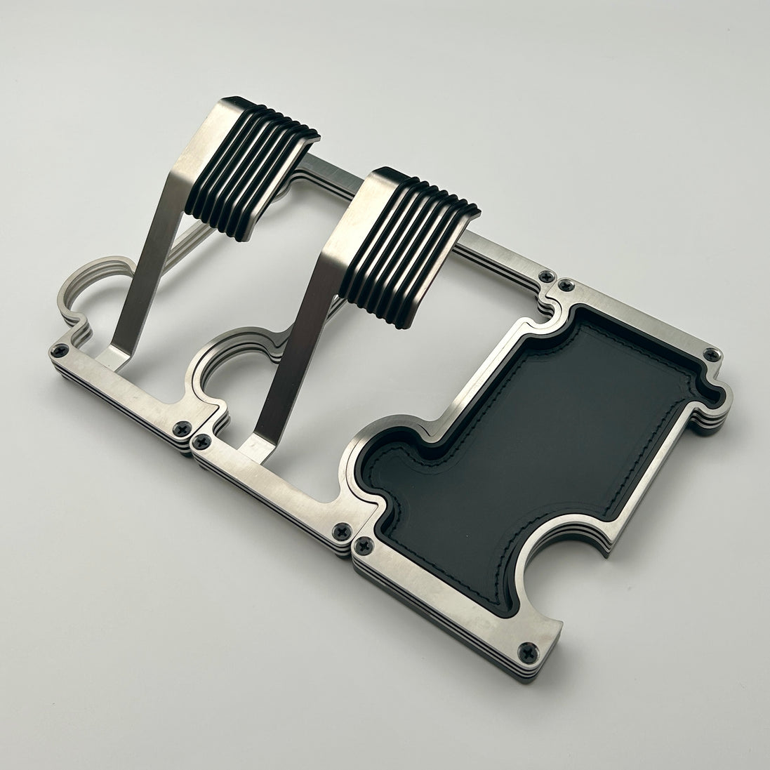 2 watch stands in brushed steel with a vanity tray also in steel