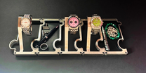 Watches displayed on a decorative stand with a dark background