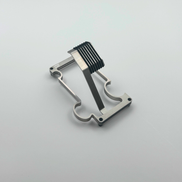 Metallic watch stand with a unique design on a light gray background