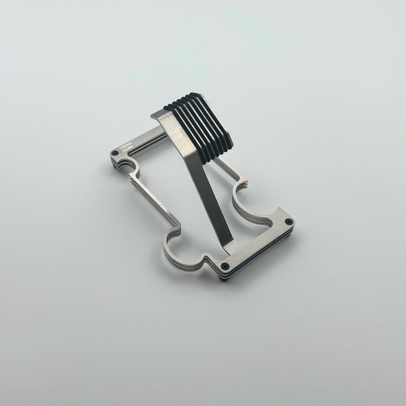 Metallic watch stand with a unique design on a light gray background