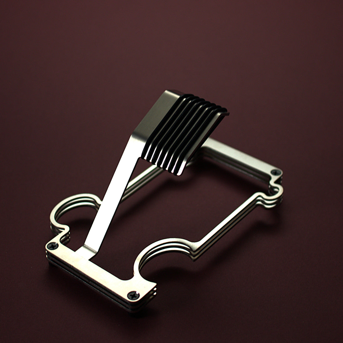 Brushed steel puzzle stand on red background