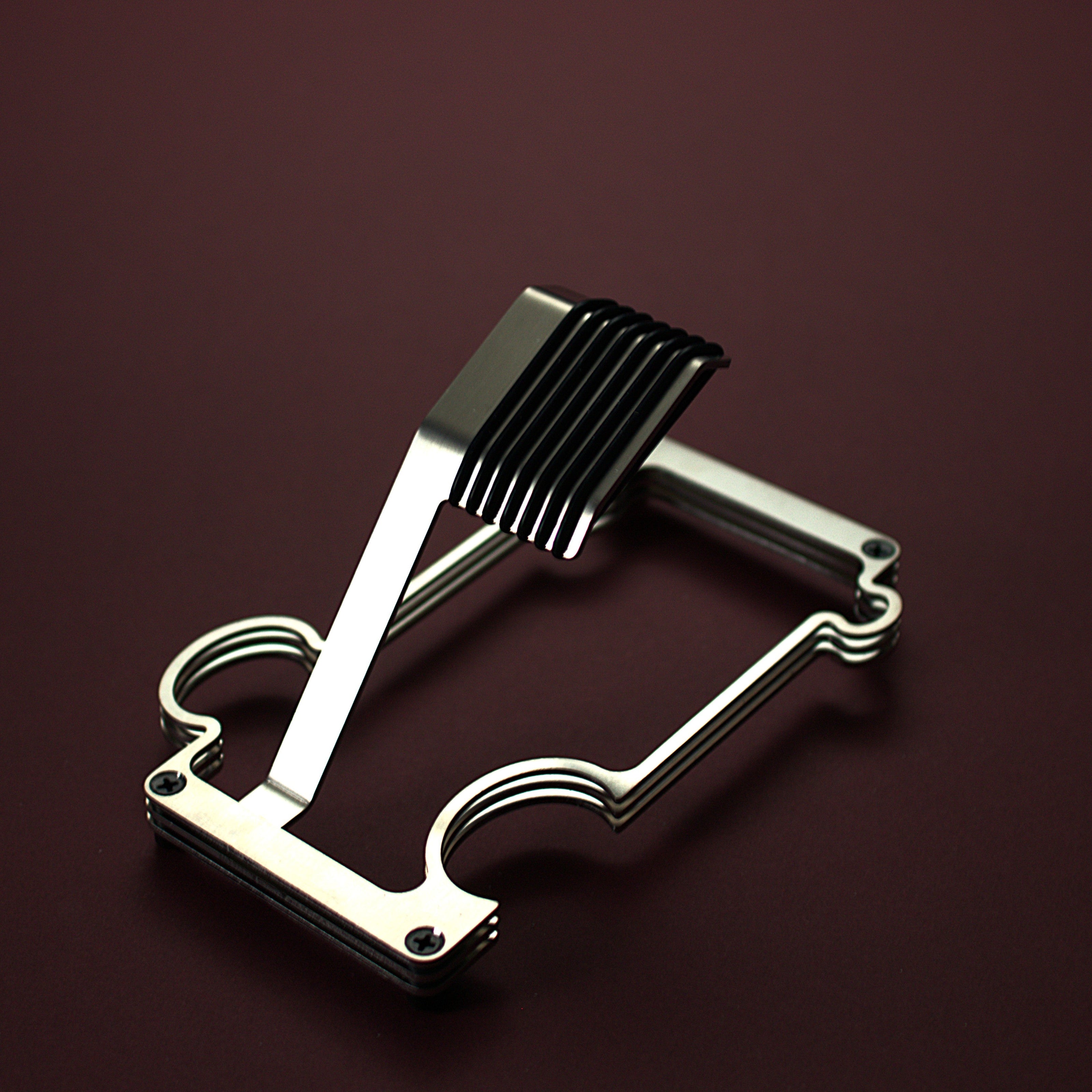 Brushed steel puzzle stand on red background
