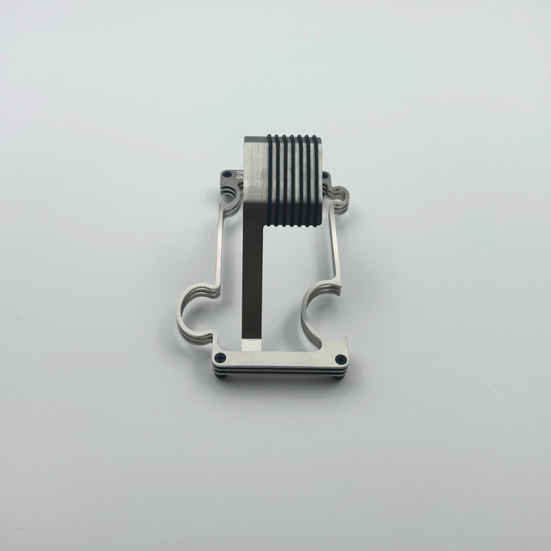 Metallic watch stand on a light gray background