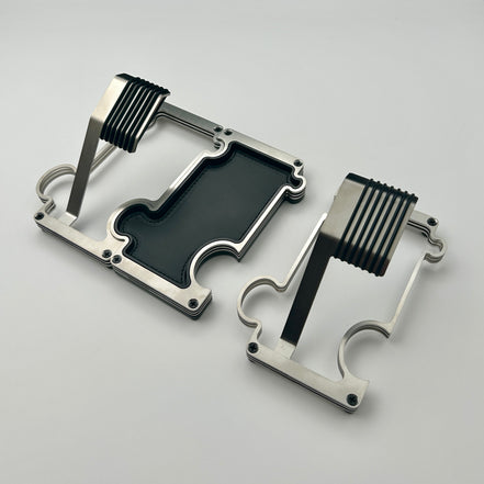 One Puzzle watch stand connected to a vanity tray in brushed steel. a separate stand sits to the right of them