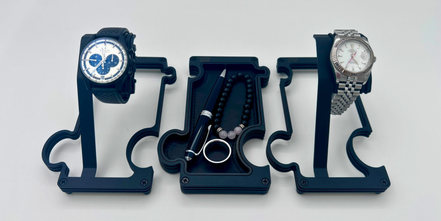 Three watch stands with watches on a white background
