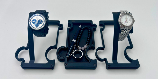 Three watch stands with watches on a white background