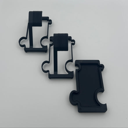 2 black metal watch stands and a black vanity tray on a white background