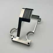 Brushed steel watch stand shaped like a puzzle piece