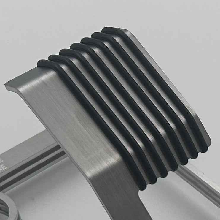 Metallic watch stand on a light gray background