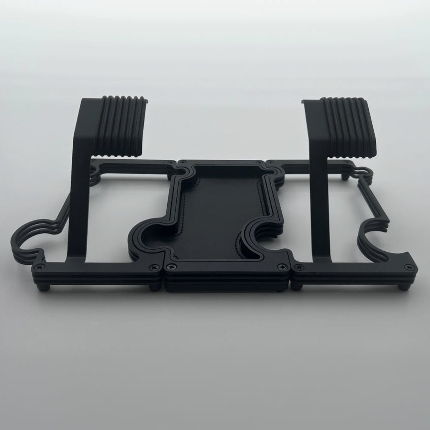 2 watch stands in black metal on either side of of a black vanity tray with black leather insert on white background