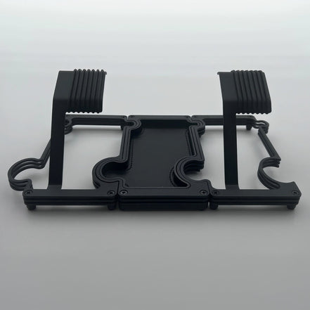2 watch stands in black metal on either side of of a black vanity tray with black leather insert on white background