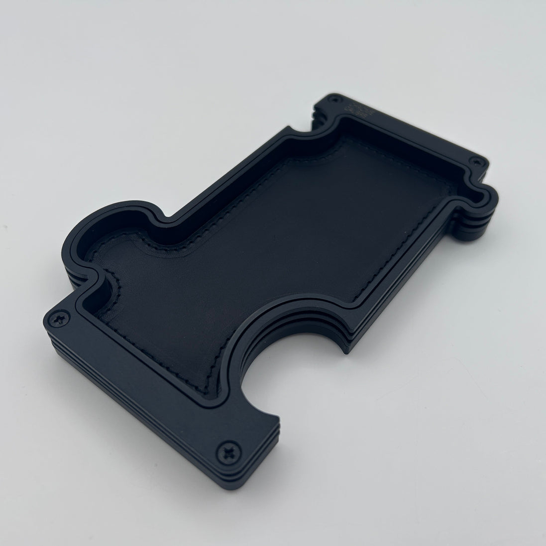 Vanity Tray with Puzzle design in black layered steel and black leather insert on white background