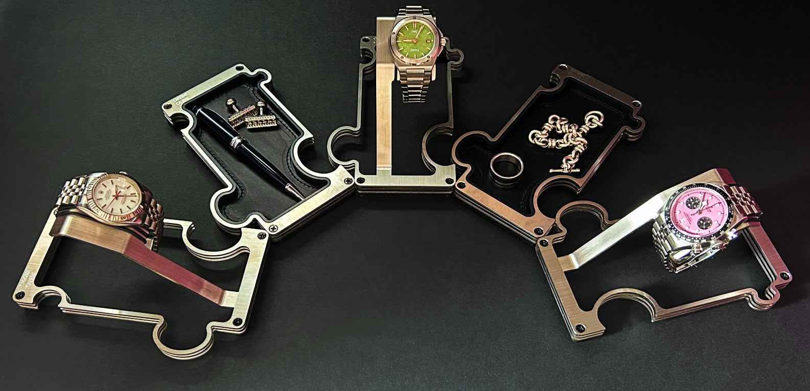 Collection of multiple watch stands on a dark background