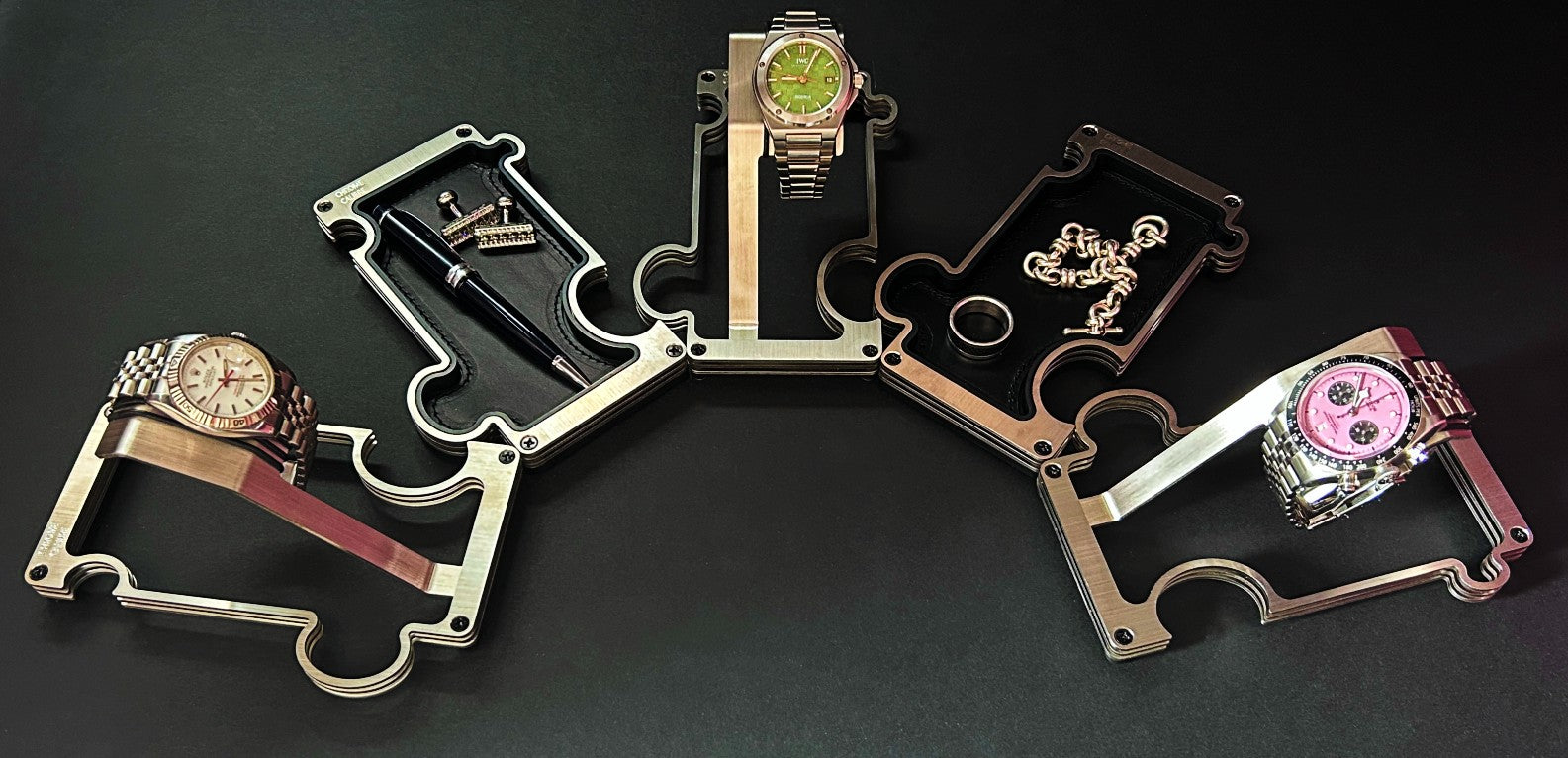Collection of multiple watch stands on a dark background