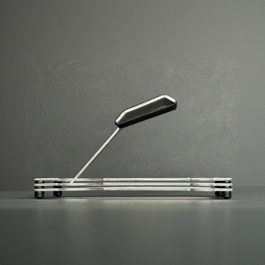 Puzzle Watch Stand showing a side view of the layered steel 