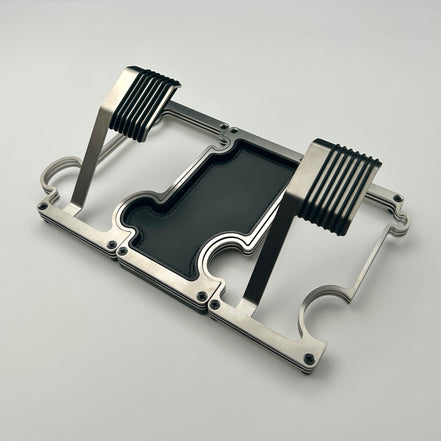 2 metal watch stands interlinked on either side of a vanity tray on a white background