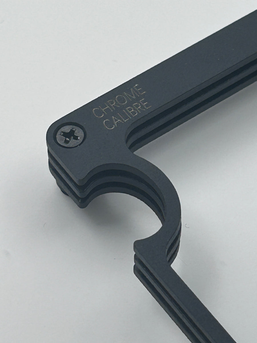 Close up image of corner of watch stand in black on white background