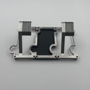 2 metal watch stands with a vanity tray between them in brushed steel with a white background