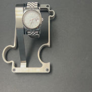 video of puzzle watch stand on grey surface showing the interlocking feature and adding a vanity tray