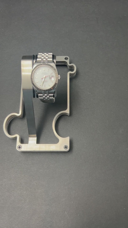 video of puzzle watch stand on grey surface showing the interlocking feature and adding a vanity tray