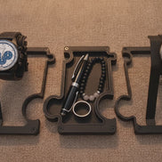 short video of  puzzle watch stands and one puzzle vanity tray on brown fabric with a light trail moving around the products